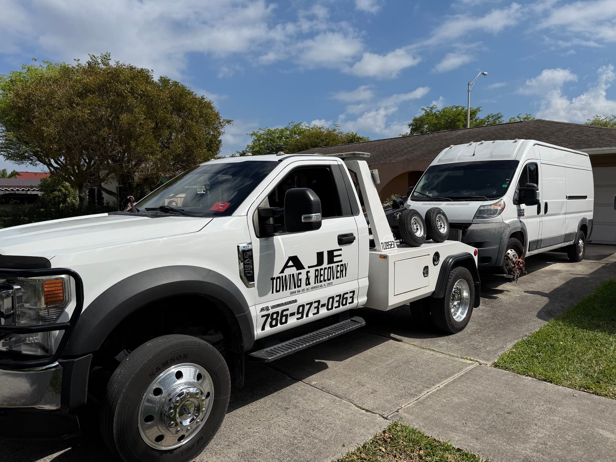 AJE Towing & Recovery flatbed on a roadside service call in South Florida
